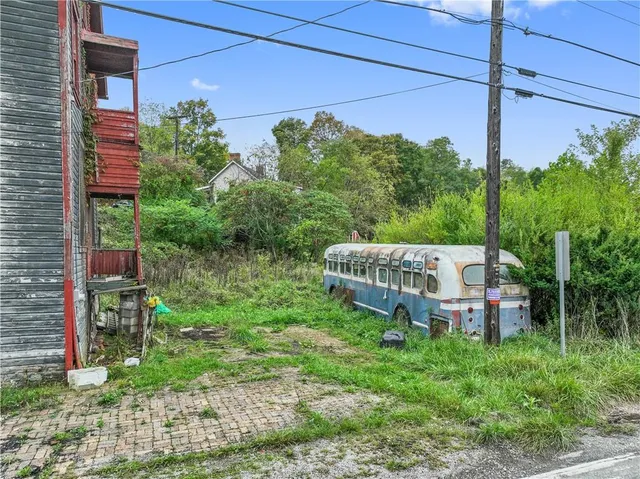 a view of a chair and table in backyard of the house