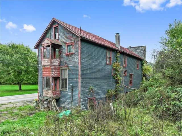a backyard of a house with table and chairs