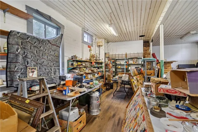 a view of a workspace with furniture and wooden floor