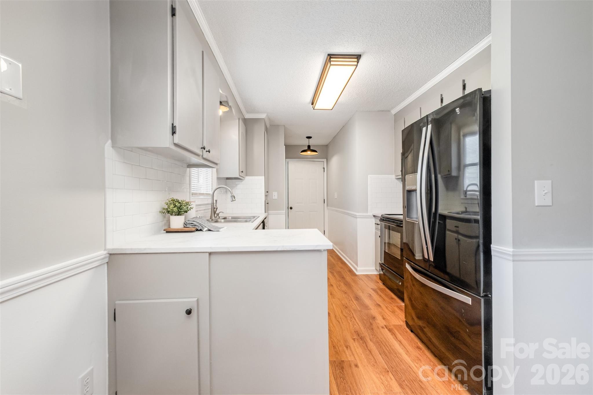 123 General Pemberton Street Stanley, NC 28164 - Photo 11 of 32 a kitchen with stainless steel appliances a sink stove and refrigerator