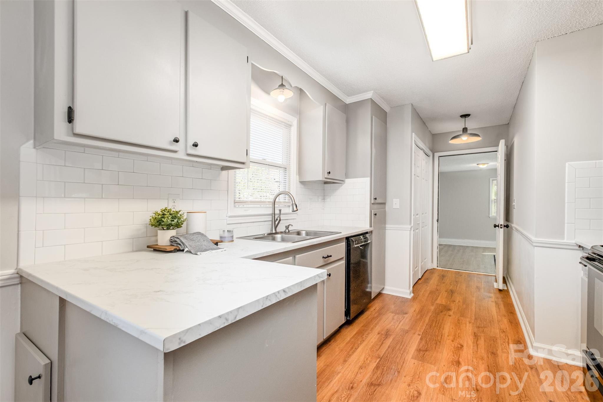 123 General Pemberton Street Stanley, NC 28164 - Photo 12 of 32 a kitchen with stainless steel appliances granite countertop a sink a stove and cabinets