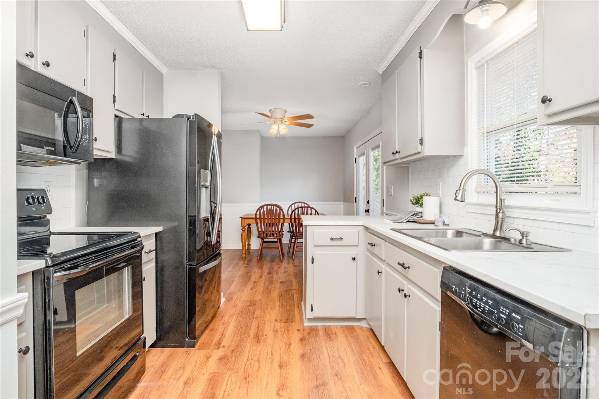 123 General Pemberton Street Stanley, NC 28164 - Photo 14 of 32 a kitchen with stainless steel appliances a sink a stove a refrigerator cabinets and a counter space
