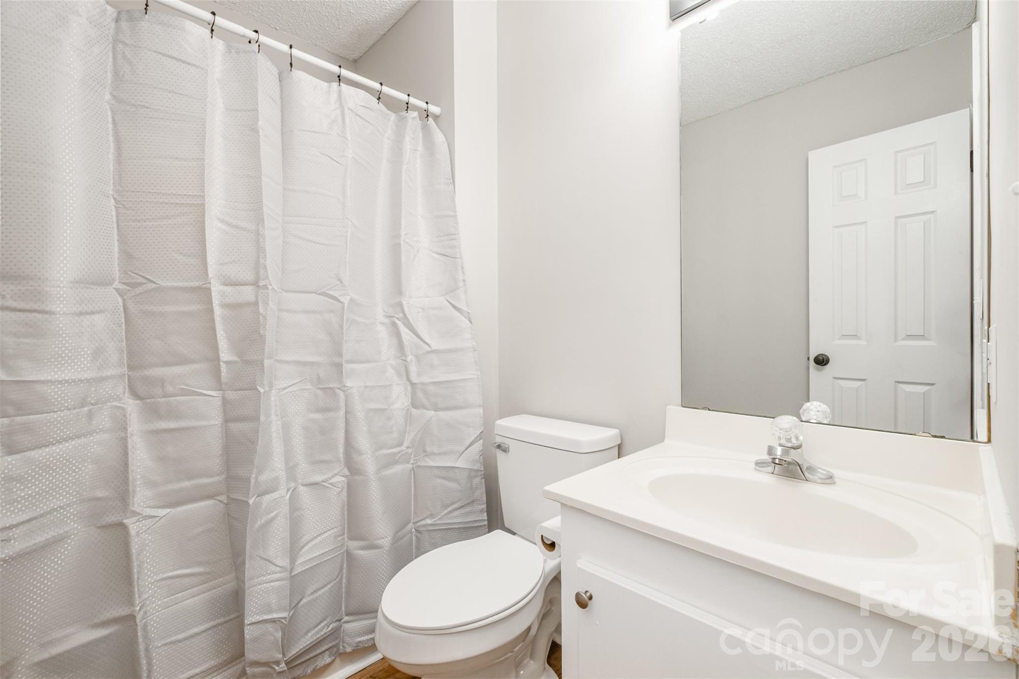 123 General Pemberton Street Stanley, NC 28164 - Photo 26 of 32 a bathroom with a sink a toilet and shower curtain