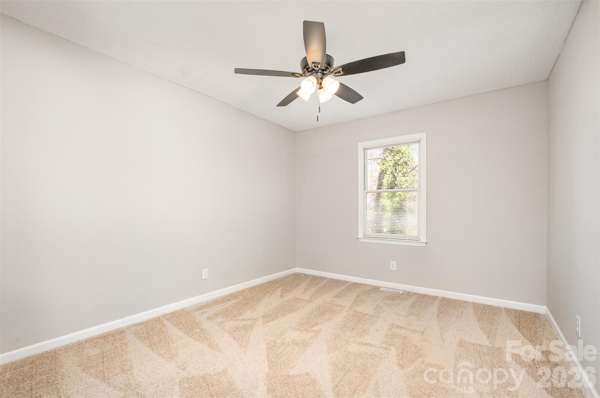 123 General Pemberton Street Stanley, NC 28164 - Photo 28 of 32 an empty room with a window and a fan