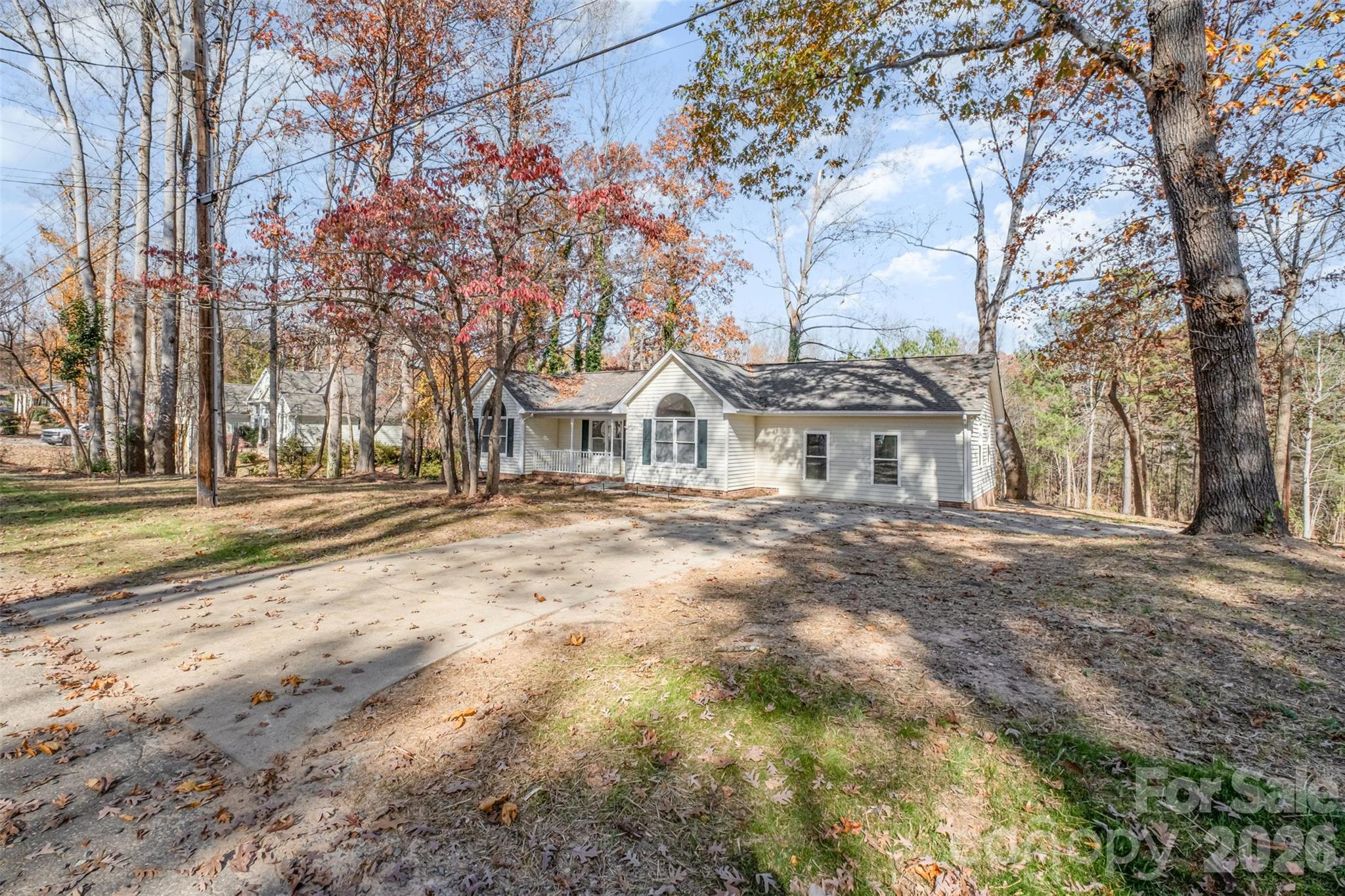 123 General Pemberton Street Stanley, NC 28164 - Photo 32 of 32 a view of a white house with a yard and large trees