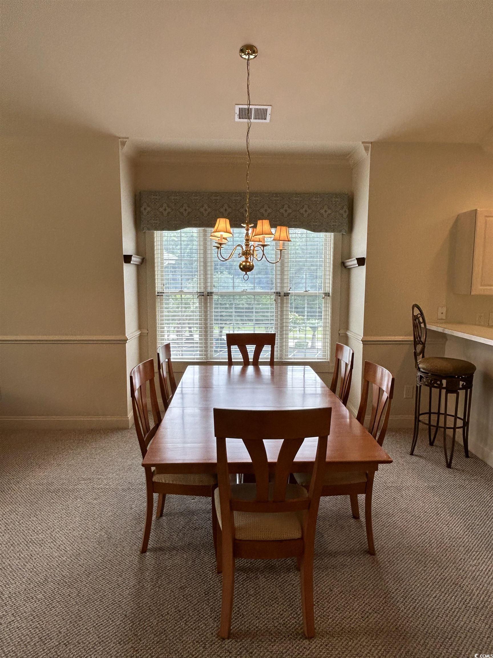 4893 Magnolia Pointe Lane, Unit 305 Myrtle Beach, SC 29577 - Photo 12 of 36 Carpeted dining space featuring a chandelier