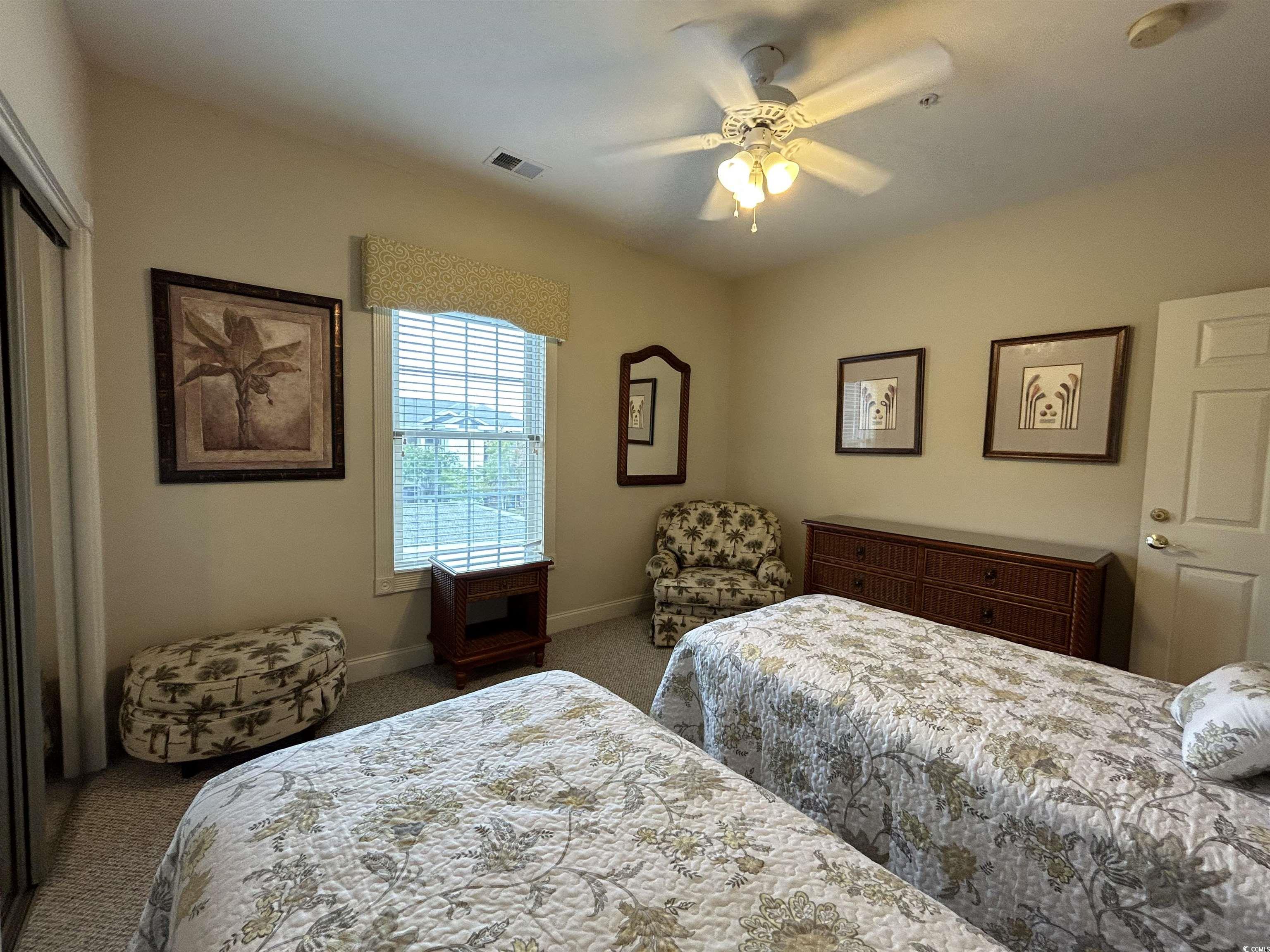 4893 Magnolia Pointe Lane, Unit 305 Myrtle Beach, SC 29577 - Photo 19 of 36 Carpeted bedroom featuring a closet and ceiling fan