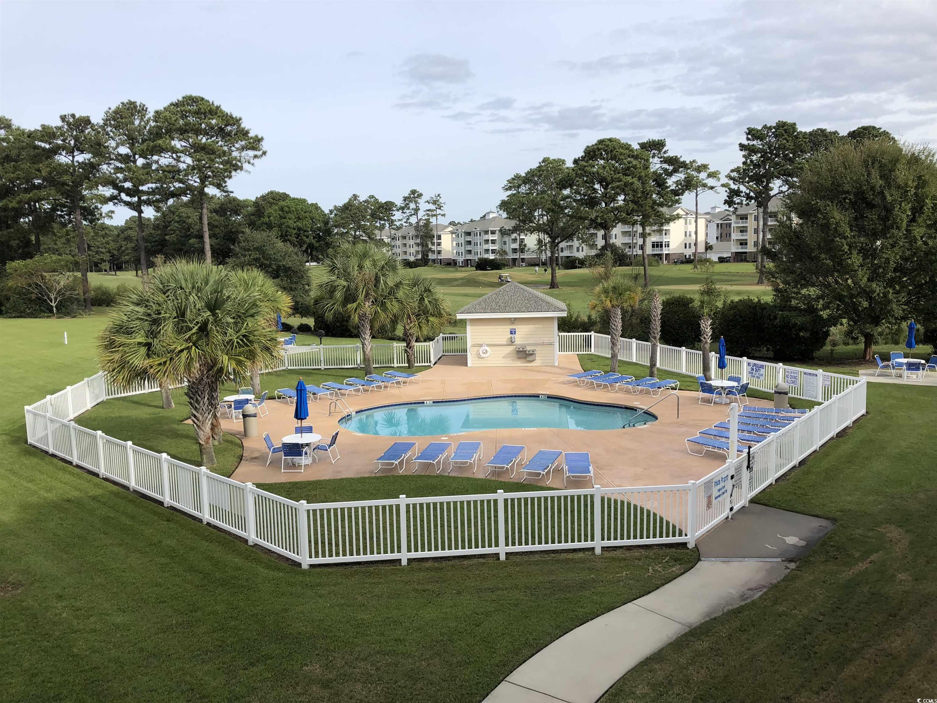 4893 Magnolia Pointe Lane, Unit 305 Myrtle Beach, SC 29577 - Photo 2 of 36 View of pool with a yard and a patio
