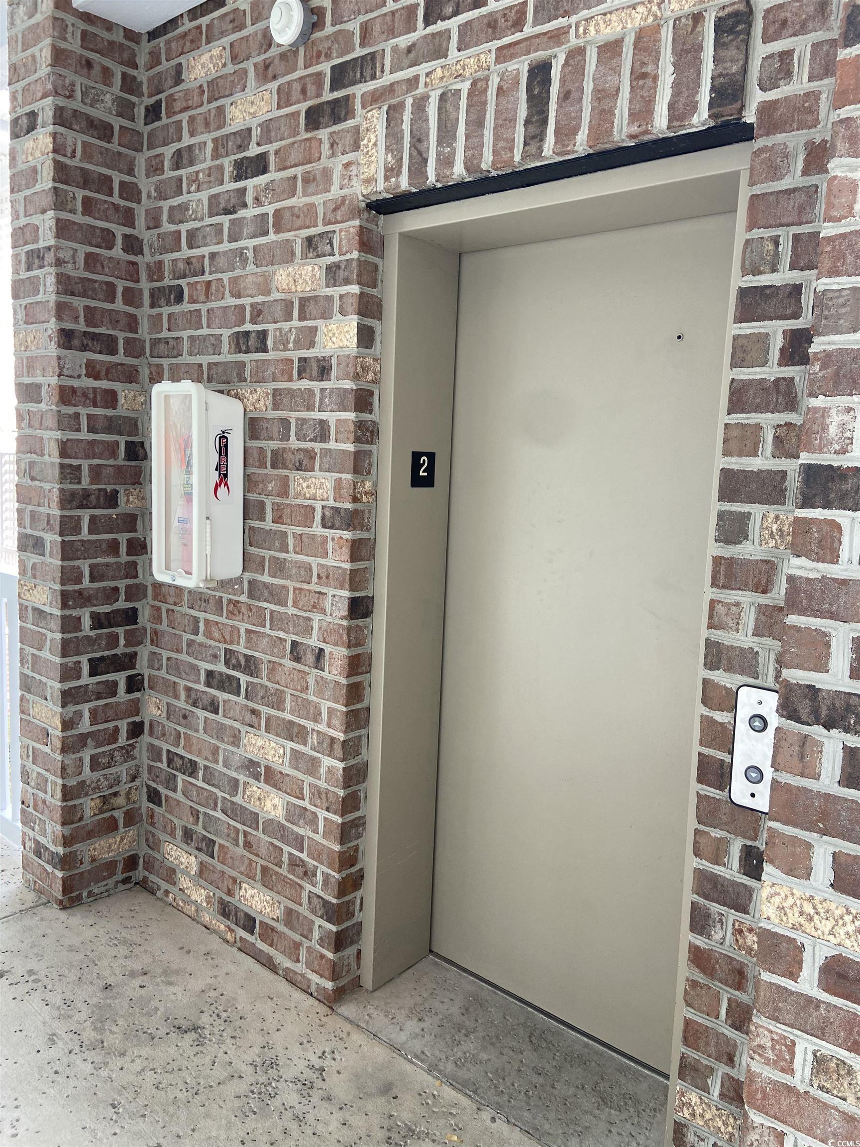 4893 Magnolia Pointe Lane, Unit 305 Myrtle Beach, SC 29577 - Photo 23 of 36 Entrance to property featuring elevator