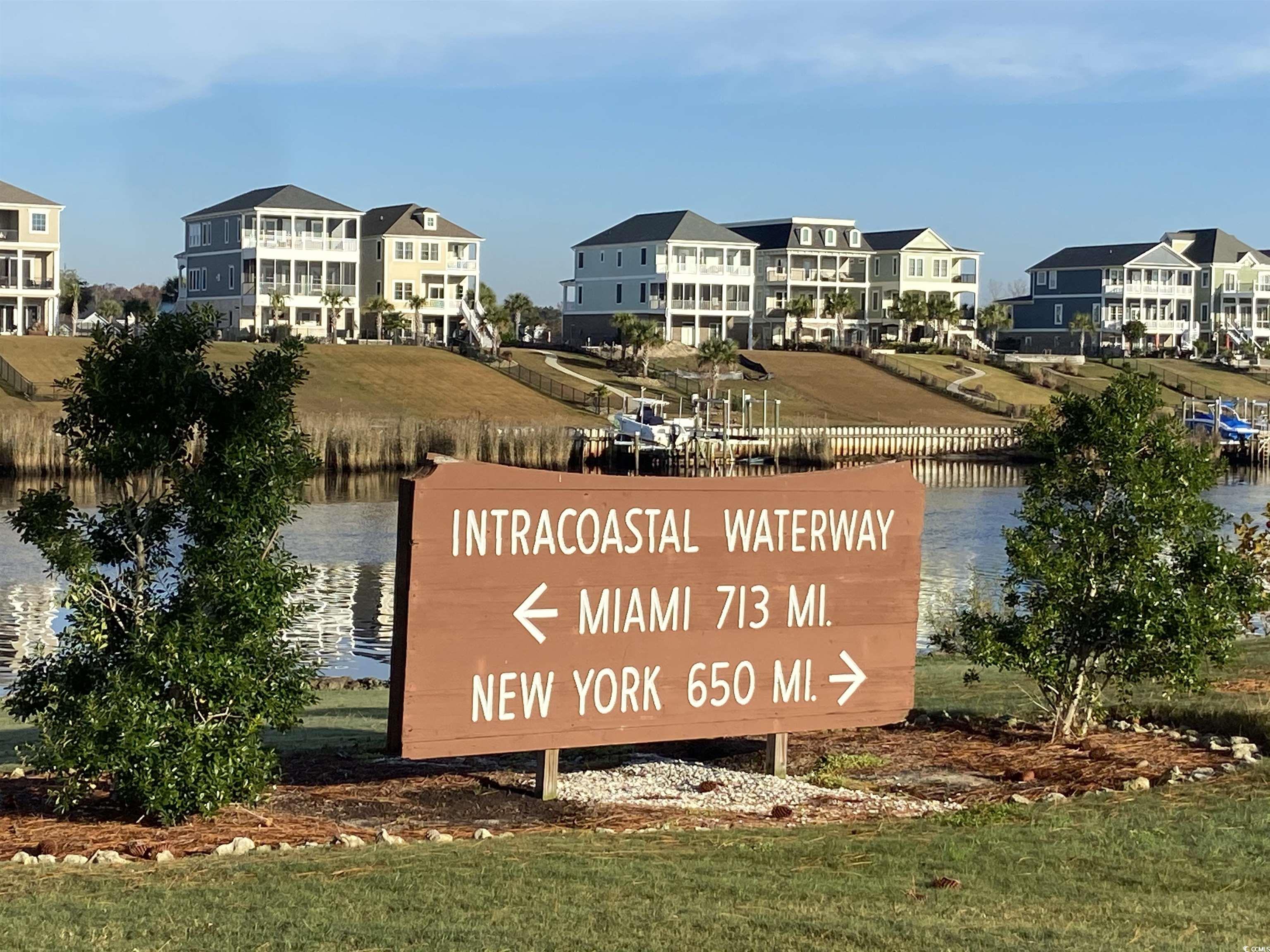 4893 Magnolia Pointe Lane, Unit 305 Myrtle Beach, SC 29577 - Photo 25 of 36 Community / neighborhood sign featuring a water view