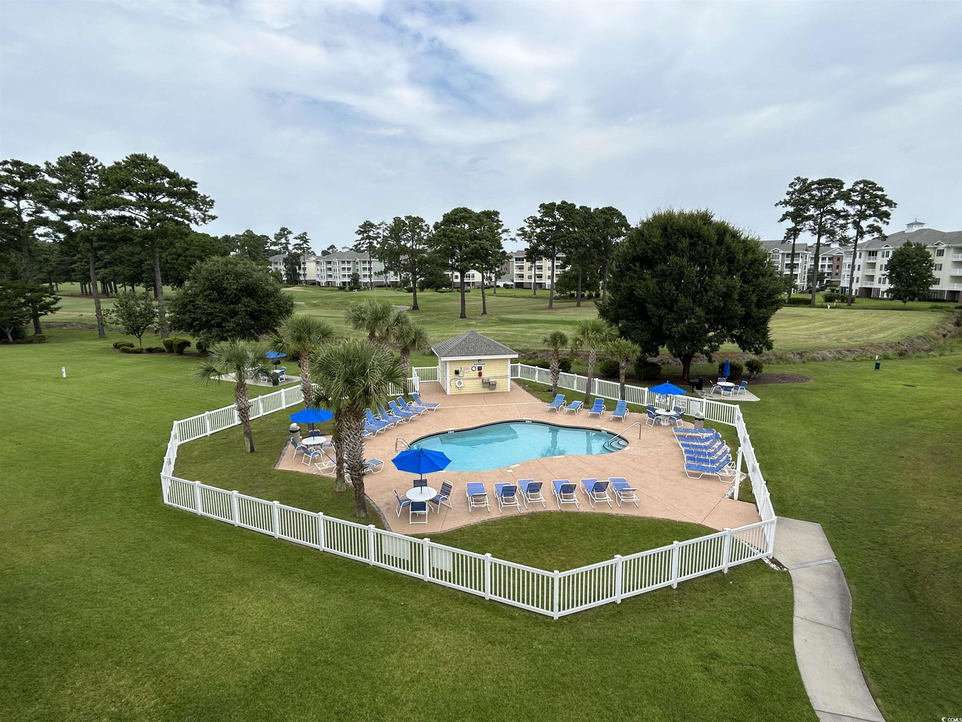 4893 Magnolia Pointe Lane, Unit 305 Myrtle Beach, SC 29577 - Photo 34 of 36 View of swimming pool featuring a lawn and a patio