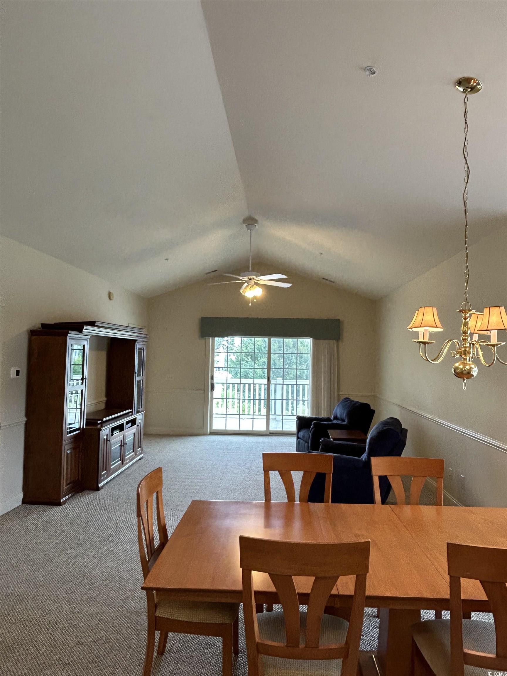 4893 Magnolia Pointe Lane, Unit 305 Myrtle Beach, SC 29577 - Photo 6 of 36 Dining room featuring vaulted ceiling, light colored carpet, and ceiling fan with notable chandelier
