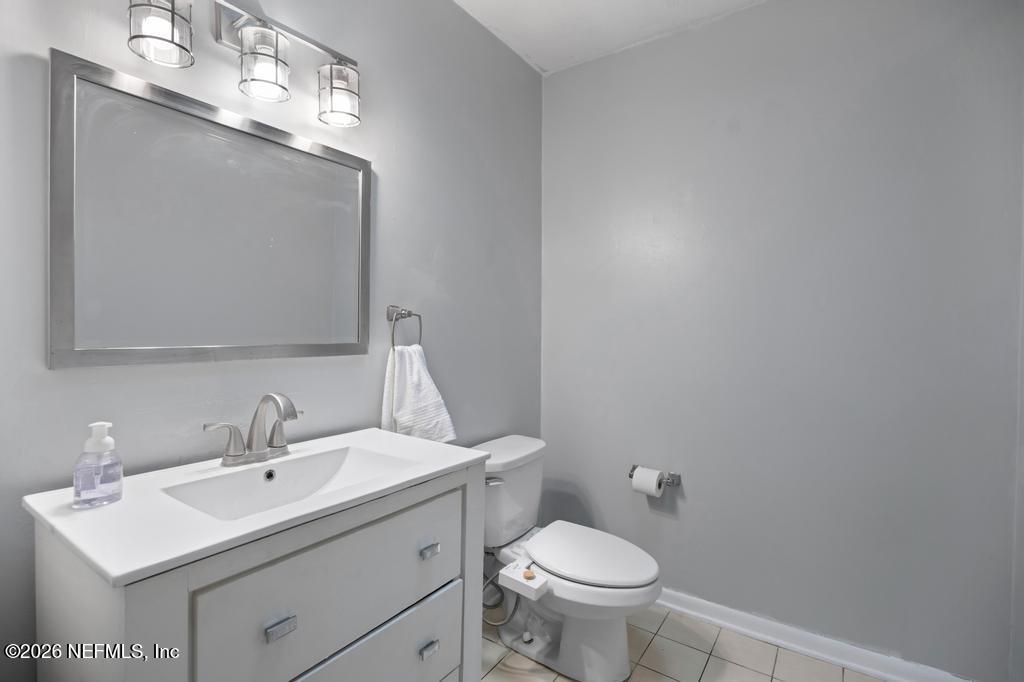 892 Trinidad Road Jacksonville, FL 32216 - Photo 20 of 37 a bathroom with a sink toilet and mirror