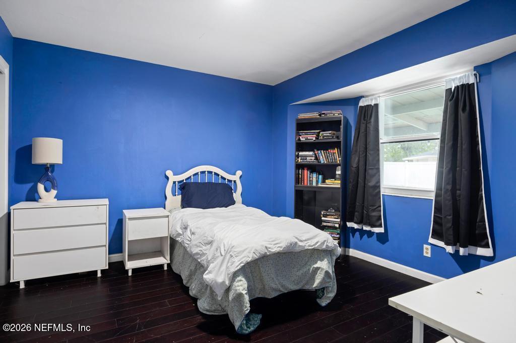 892 Trinidad Road Jacksonville, FL 32216 - Photo 26 of 37 a bedroom with a bed and a flat tv screen on dresser