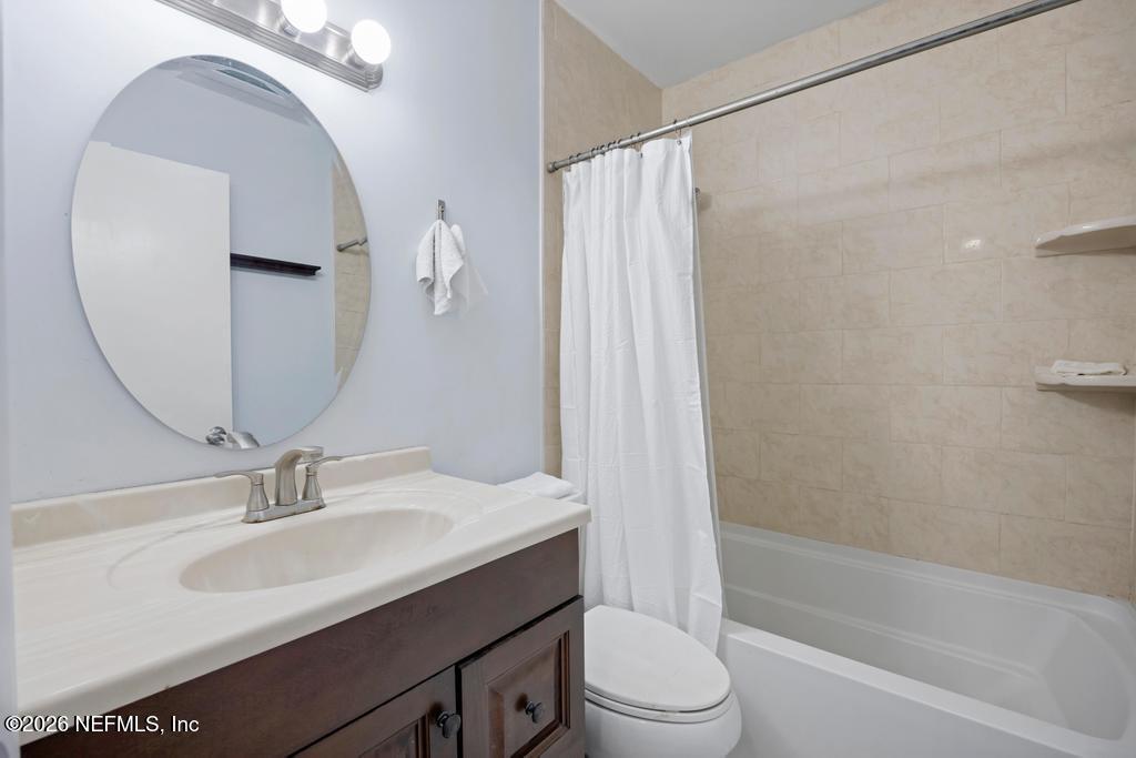 892 Trinidad Road Jacksonville, FL 32216 - Photo 28 of 37 a bathroom with a sink a toilet and a mirror