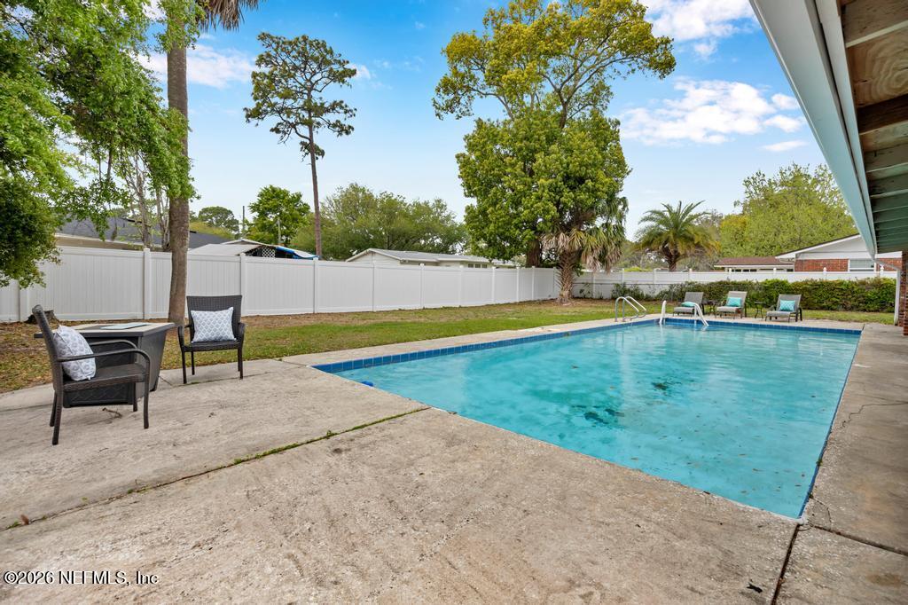 892 Trinidad Road Jacksonville, FL 32216 - Photo 31 of 37 a view of swimming pool with a yard and sitting area