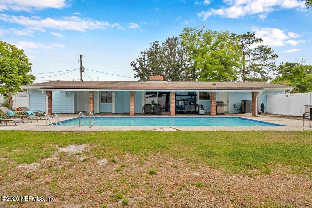 892 Trinidad Road Jacksonville, FL 32216 - Photo 32 of 37 a view of a house with swimming pool and a yard
