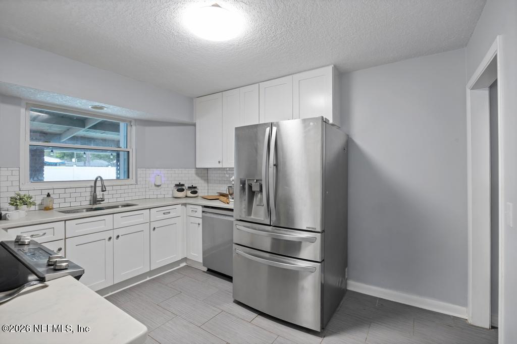 892 Trinidad Road Jacksonville, FL 32216 - Photo 10 of 37 a kitchen with a refrigerator and a sink
