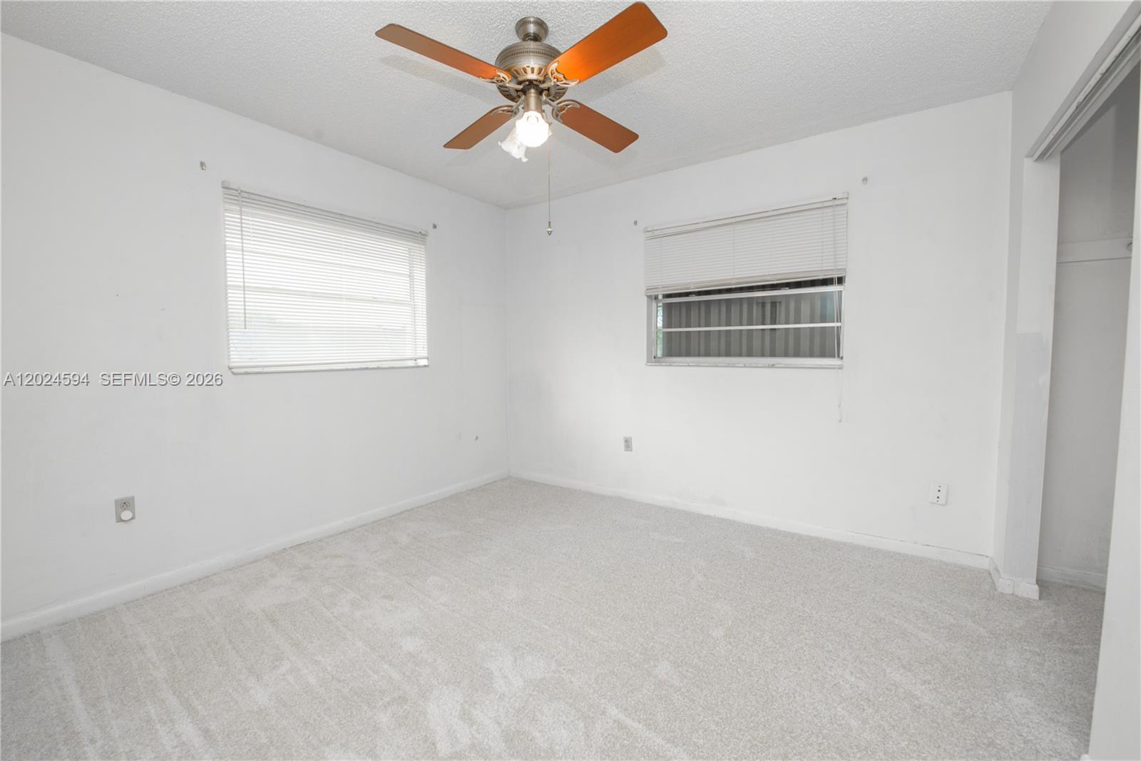17355 Southwest 256th Street Homestead, FL 33031 - Photo 21 of 32 an empty room with a window and a fan