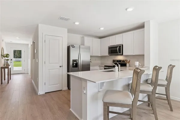 a kitchen with stainless steel appliances a refrigerator stove microwave and cabinets