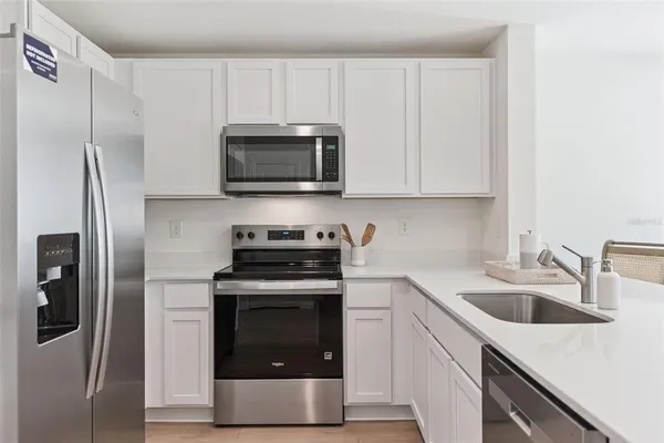 a kitchen with a sink stove and refrigerator