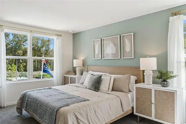 a bedroom with a large bed and a window with outer view