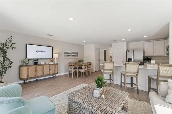 a living room with furniture and wooden floor