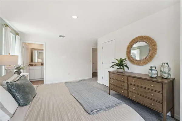 a bedroom with a bed and a dresser