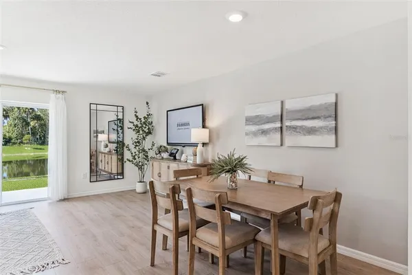 a view of a dining room with furniture and wooden floor