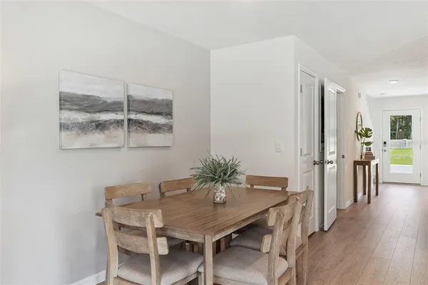 a view of a dining room with furniture and wooden floor