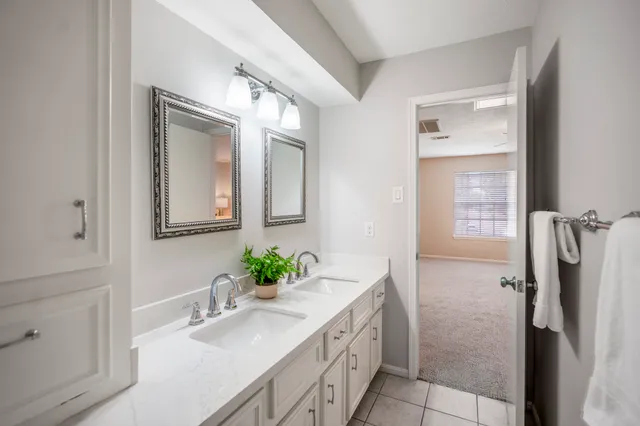 a bathroom with a granite countertop sink a mirror and a shower