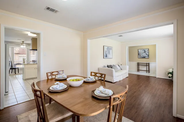 a view of a dining room with furniture and wooden floor
