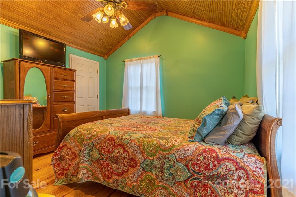 5743 Camp Creek Road Lancaster, SC 29720 - Photo 13 of 20 a bedroom with a bed and a chandelier