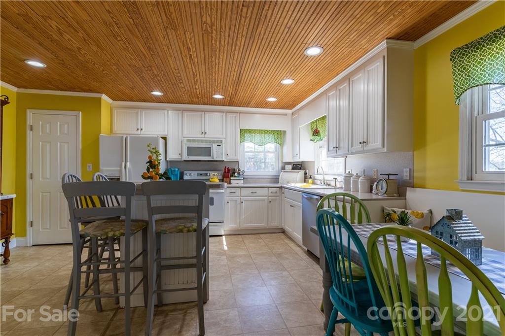 5743 Camp Creek Road Lancaster, SC 29720 - Photo 6 of 20 a kitchen with a table chairs microwave and cabinets
