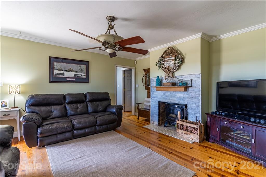 5743 Camp Creek Road Lancaster, SC 29720 - Photo 7 of 20 a living room with furniture a fireplace and a flat screen tv