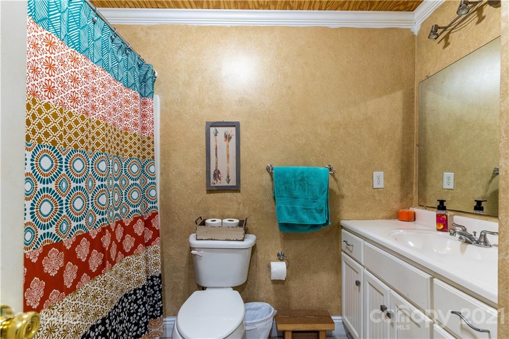 5743 Camp Creek Road Lancaster, SC 29720 - Photo 10 of 20 a bathroom with a sink mirror vanity and toilet