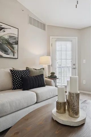 a living room with furniture and a fireplace