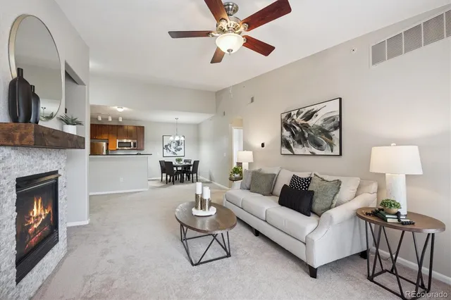 a living room with furniture and a fireplace