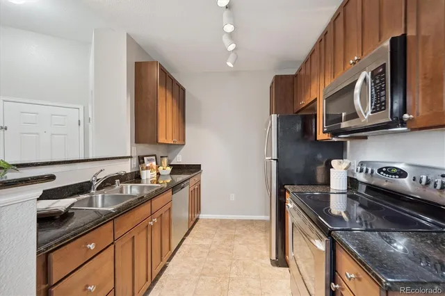 a kitchen that has a sink and a stove
