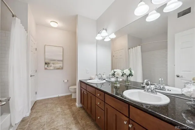 a bathroom with a double vanity sink and a mirror