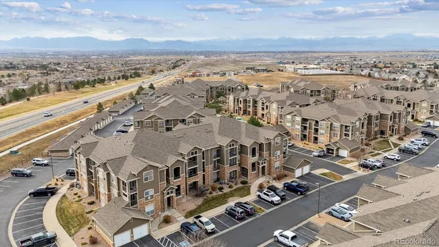 an aerial view of a residential apartment building with a yard