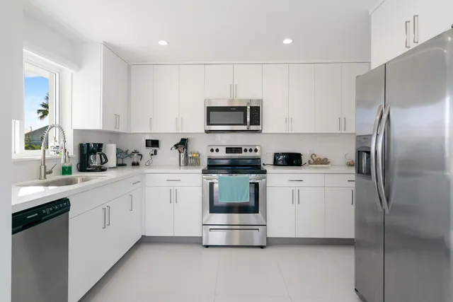 a kitchen with sink a counter top space and appliances