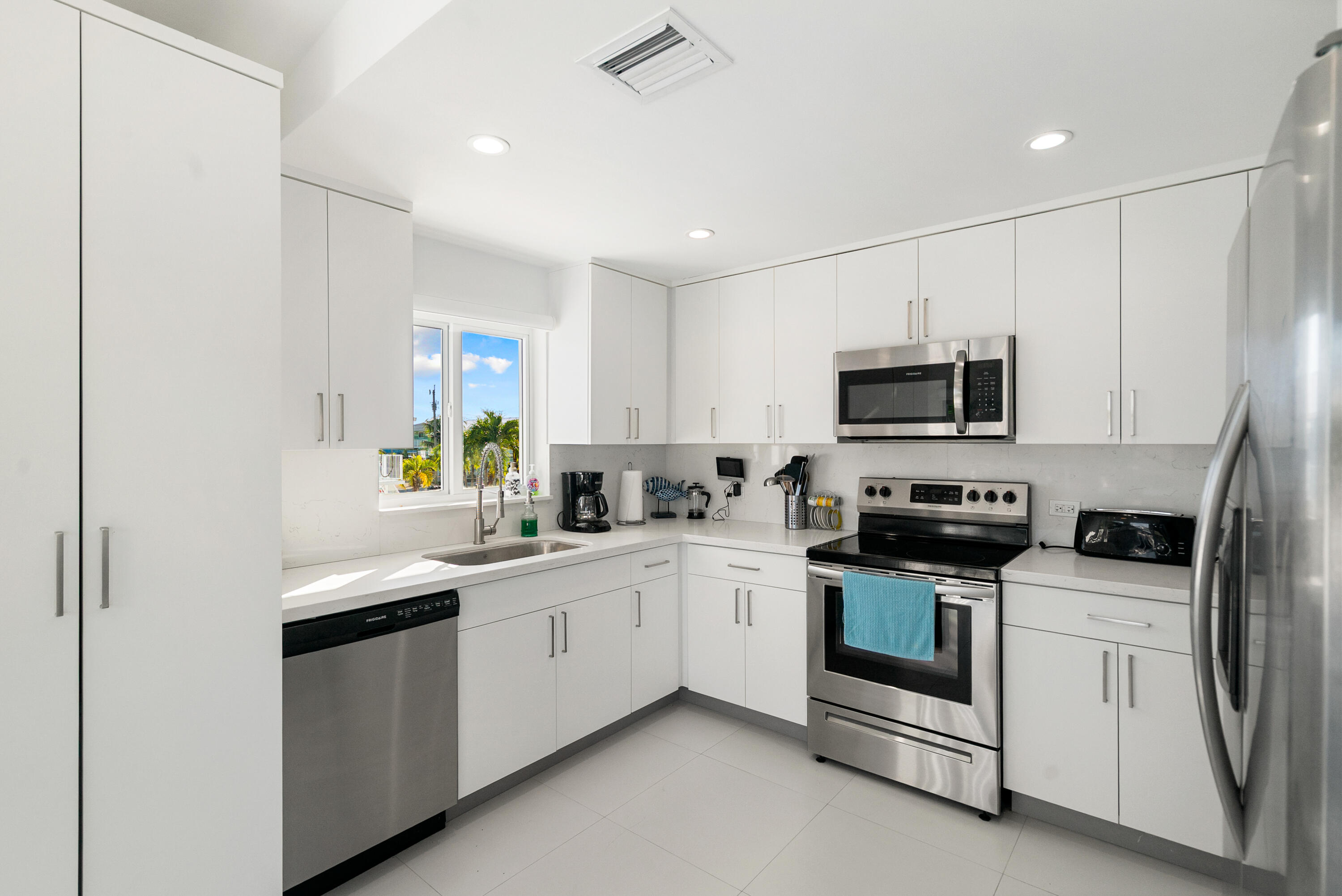 204 La Paloma Road Key Largo, FL 33037 - Photo 20 of 35 a kitchen with white cabinets appliances and a sink