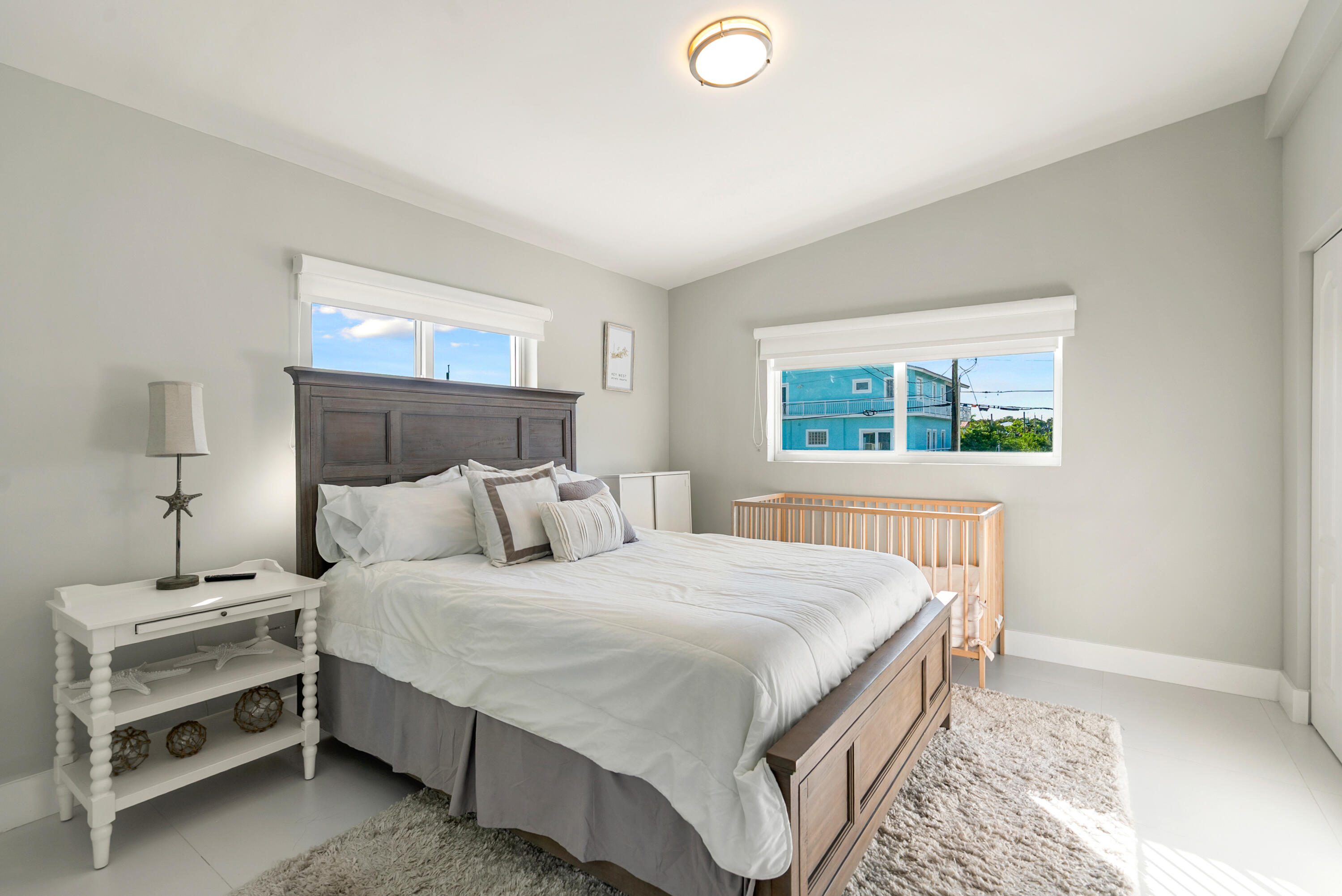 204 La Paloma Road Key Largo, FL 33037 - Photo 24 of 35 a bedroom with a bed and a window