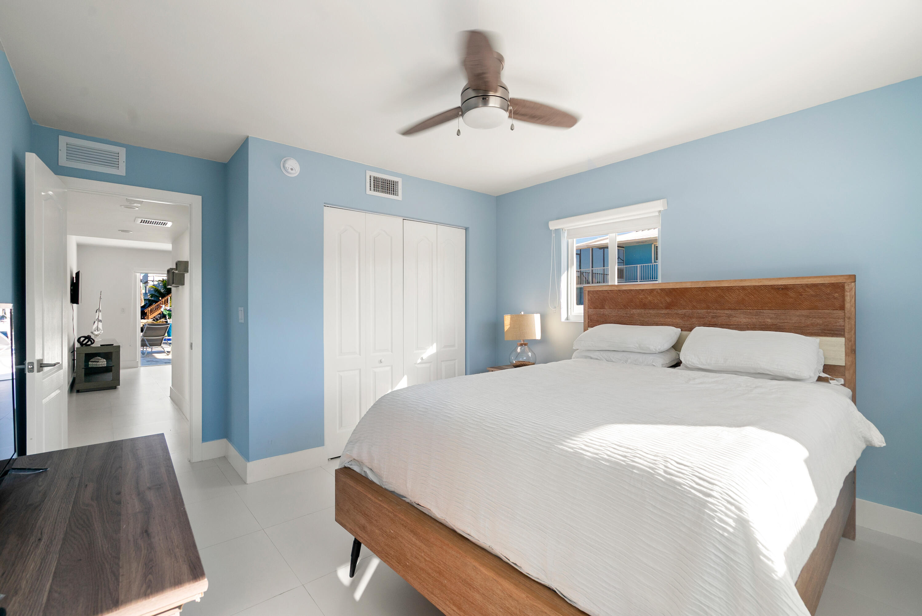 204 La Paloma Road Key Largo, FL 33037 - Photo 30 of 35 a bedroom with a bed and a chandelier