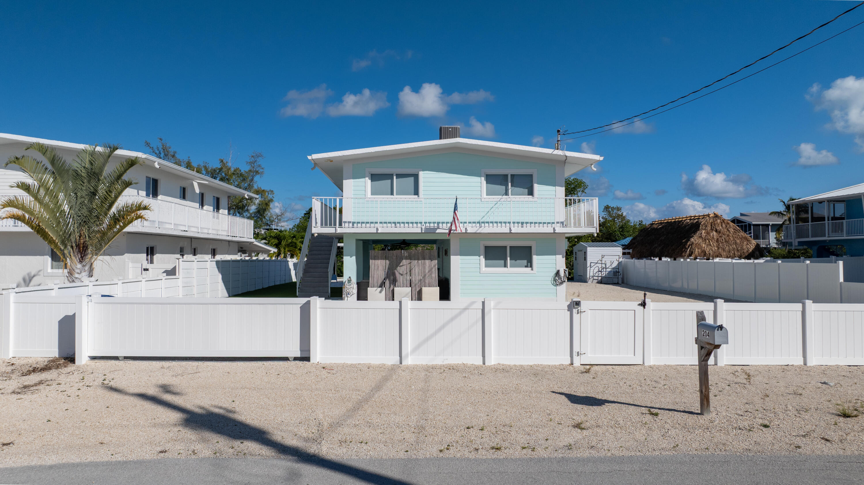 204 La Paloma Road Key Largo, FL 33037 - Photo 3 of 35 a front view of a house with a couch