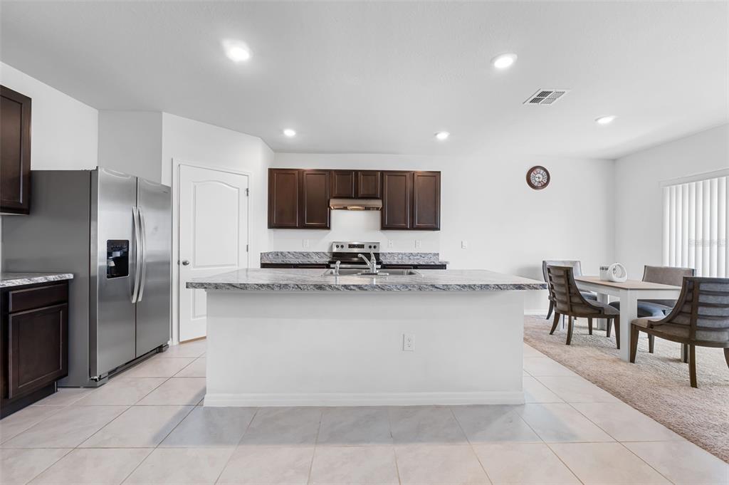821 Sun Burst Road Winter Haven, FL 33880 - Photo 15 of 86 a large kitchen with cabinets table and chairs