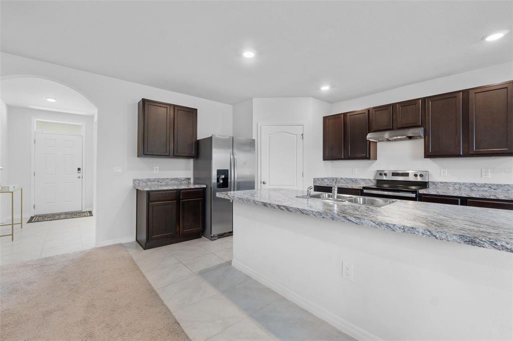 821 Sun Burst Road Winter Haven, FL 33880 - Photo 16 of 86 a large kitchen with a large counter top appliances and cabinets