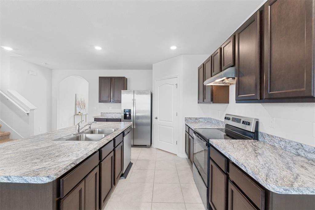 821 Sun Burst Road Winter Haven, FL 33880 - Photo 17 of 86 a kitchen with stainless steel appliances granite countertop a sink stove and cabinets