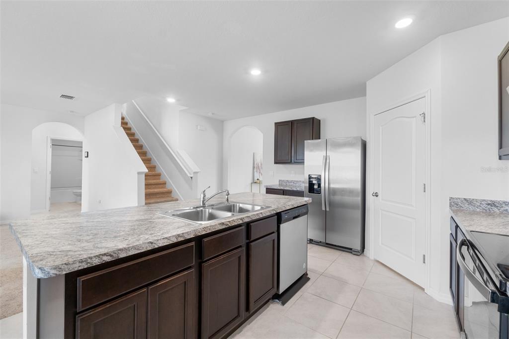821 Sun Burst Road Winter Haven, FL 33880 - Photo 22 of 86 a kitchen with a sink and refrigerator